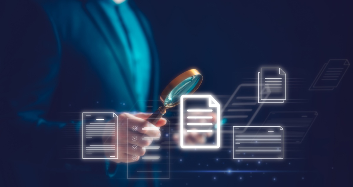 chest of a lawyer in a business suit holding a magnifying glass over floating images of electronic pages