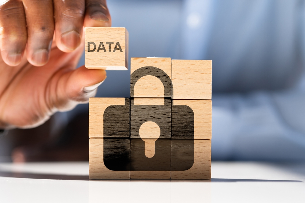 Privacy concept with wooden blocks stacked together showing a lock and the word "data"